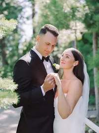 film photo of bride and groom in the woods