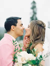 intimate film photo of bride and groom smiling at each other close up