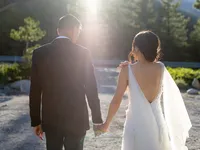 bride and groom walking away into the sunset