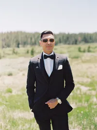 groom posing in tahoe meadow looking stud and with sunglasses