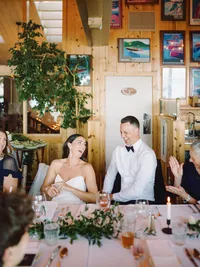 bride and groom laughing at their wedding speeches