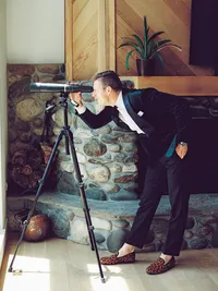 groom getting ready photo looking through telescope