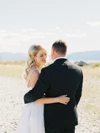 bride and groom posing on the beach