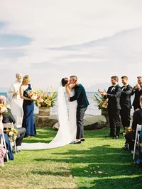 bride and groom first kiss on the beach wedding ceremony