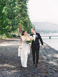bride and groom walking down the pebble beach in lake Tahoe
