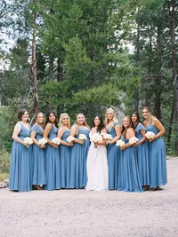bridesmaids posing in dusty blue dresses