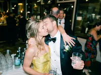 guests at the wedding reception kissing
