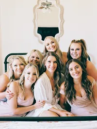 film photo of bride and bridesmaids on the bed