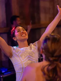 bride is dancing with hands in the air