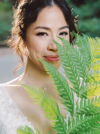 close up romantic bridal portrait holding huge fern