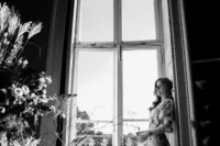 cinematic portrait of a bride leaning against window at beckenham place mansion wedding venue in south london