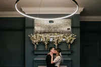 first kiss in front of fireplace at knightsbridge room of old marylebone town hall