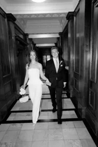 micro wedding with bride in stylish suit and groom in black exiting mayfair room of marylebone town hall