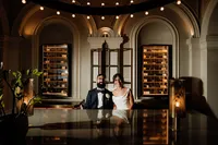 creative flash wedding photo of bride and groom sitting at andaz hotel bar