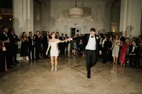 bride in a min iwedding dress and groom in black tie entering dancefloor at andaz hotel in london