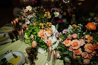 detail photo of table set up for wedding at andaz with green cloth and lots of centre florals