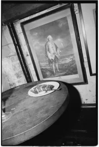 Editorial wedding photography of a plate with wedding cake captured on film