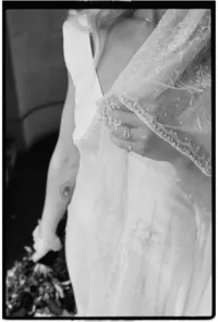 Detail editorial photo of brides hand holding a veil captured by London film wedding photographer