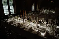 cinematic photography at lincolns inn member common room set up for reception with white flowers and modern tables