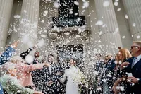 white confetti exit at iconic steps of old marylebone town hall