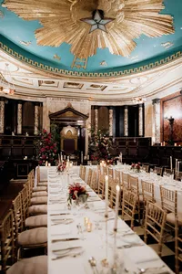 masonic temple at andaz with blue and gold ceiling set up for evening wedding dinner