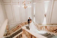wedding couple posing at marble staircase of andaz hotel for an artistic photo