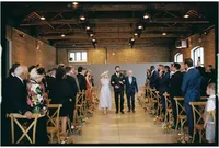 Nostalgic wedding photo of groom walking down the aisle with parents at trinity buoy wharf captured on film