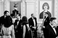 candid photo of wedding guests at andaz lounge bar in front of modern art