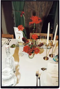 Analogue wedding photography of red flowers on reception tables at Brunswick house winter wedding taken by film wedding photographer