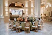 editorial photo of a round table with huge floral centre and green colours set up for 1901 ballroom wedding at andaz