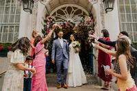 confetti exit of bride in Indian sari dress and groom in blue suit at the Chelsea Old Town Hall