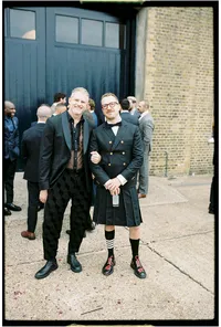 Analogue wedding photography of a gay couple in fashion forward outfits at trinity buoy wharf wedding