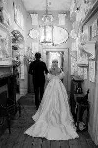 bride and groom walking into brunswick house for their wedding reception in london