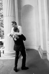 fun couple photo nostalgic blurry bride lifted in the air at marylebone town hall