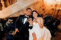 fun wedding photo with bride and groom showing off their rings and laughing with direct flash at andaz hotel