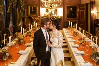 bride and groom kissing inside brunswick house wedding reception room