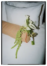 editorial film wedding photographer - detail photo of modern bridal bouquet on a bed