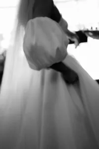 artistic wedding detail photograph of bride's arm in balloon sleeve at marylebone ceremony