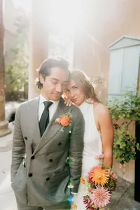 editorial couple portrait with bride leaning on groom with sunflare behind