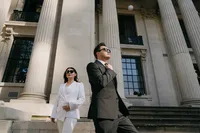 artistic cinematic wedding photography of bride in white suit and groom in tux and sunglasses