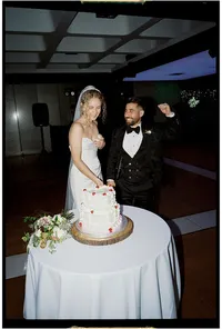 Candid wedding photography of couple cutting the cake taken on film with direct flash
