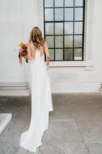 editorial portrait of bride from the back with long dress on marylebone town hall steps