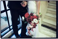 Soft blurry detail of photo of bridal flowers in red tones taken by film wedding photographer in old Marylebone town hall