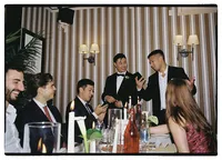 candid wedding photography of groom showing ring to friends at a london pub