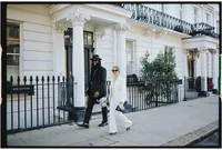 analogue wedding photo of interracial couple walking streets of London captured on 35mm