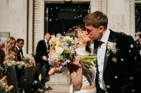 couple kissing in confetti outside 1901 ballroom at andaz hotel