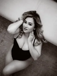 Black and white boudoir portrait of a woman in a black bodysuit, Long Beach boudoir photography