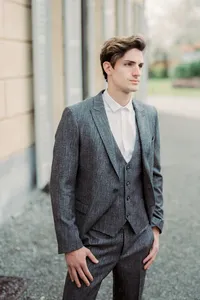 man-gray-suit-stands-near-old-villa-como-italy