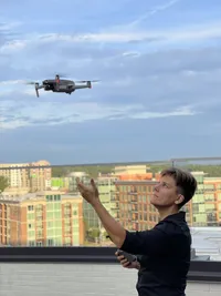 A photographer launching a drone into the sky
