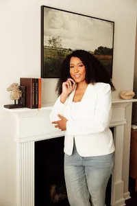 woman standing leaning against fireplace